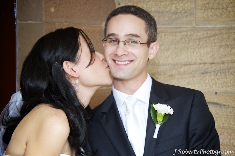 Bride kissing groom - wedding photography sydney
